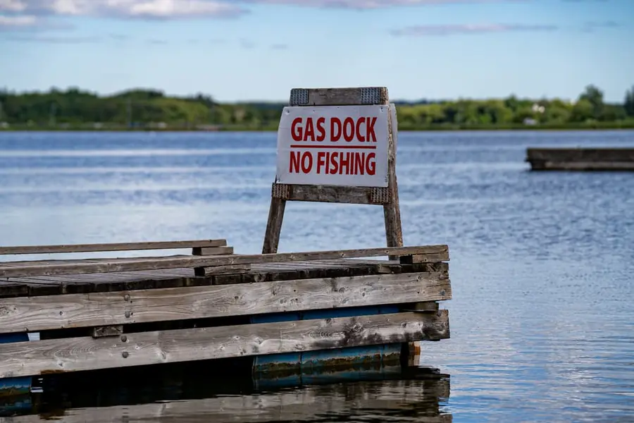 Weathered marina gas dock with a hand-painted GAS DOCK / NO FISHING sign.