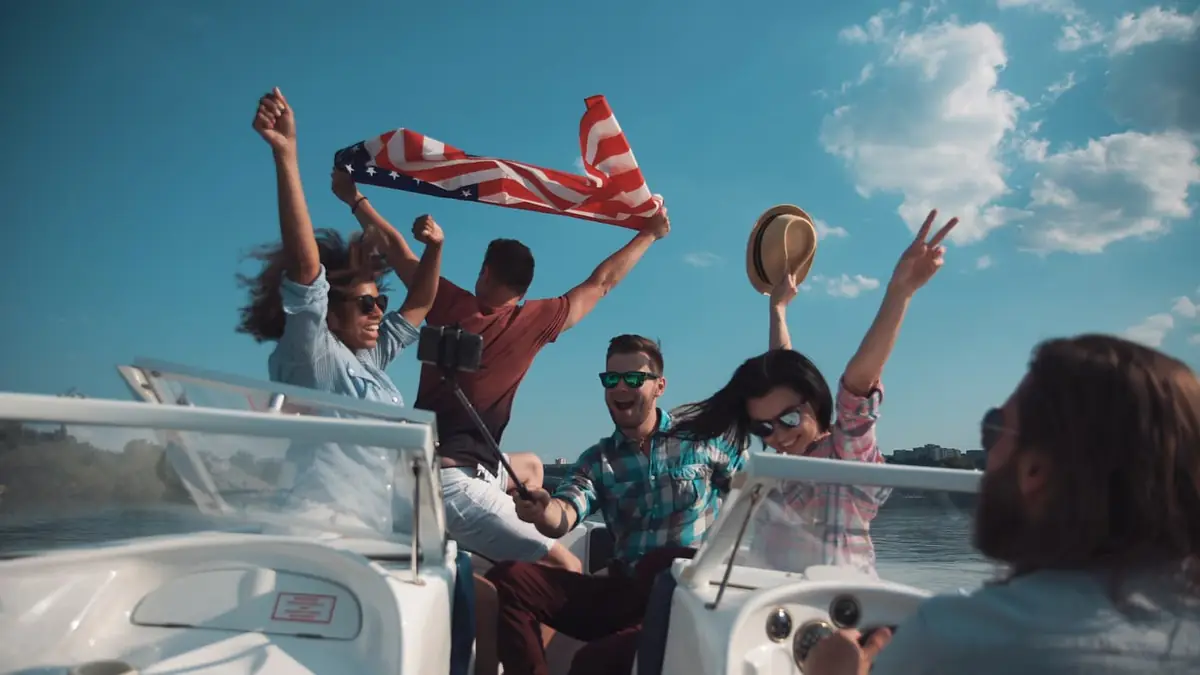 A group of friends raising an American flag on a boat.